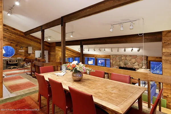 a dining room with furniture and a large window