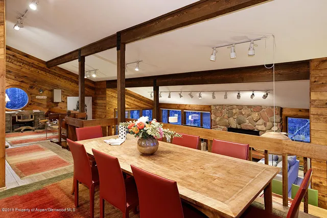 a dining room with furniture and a large window