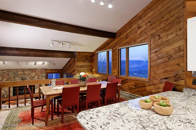 a room with furniture a rug and a fireplace