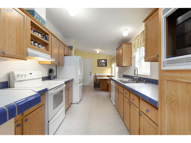 a kitchen with stainless steel appliances granite countertop a stove a sink dishwasher and a microwave