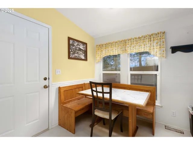 a view of a dining room with furniture and a potted plant