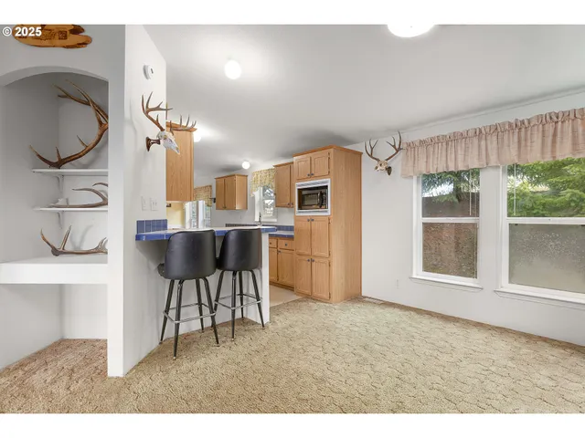 a living room with a sink furniture and a large window