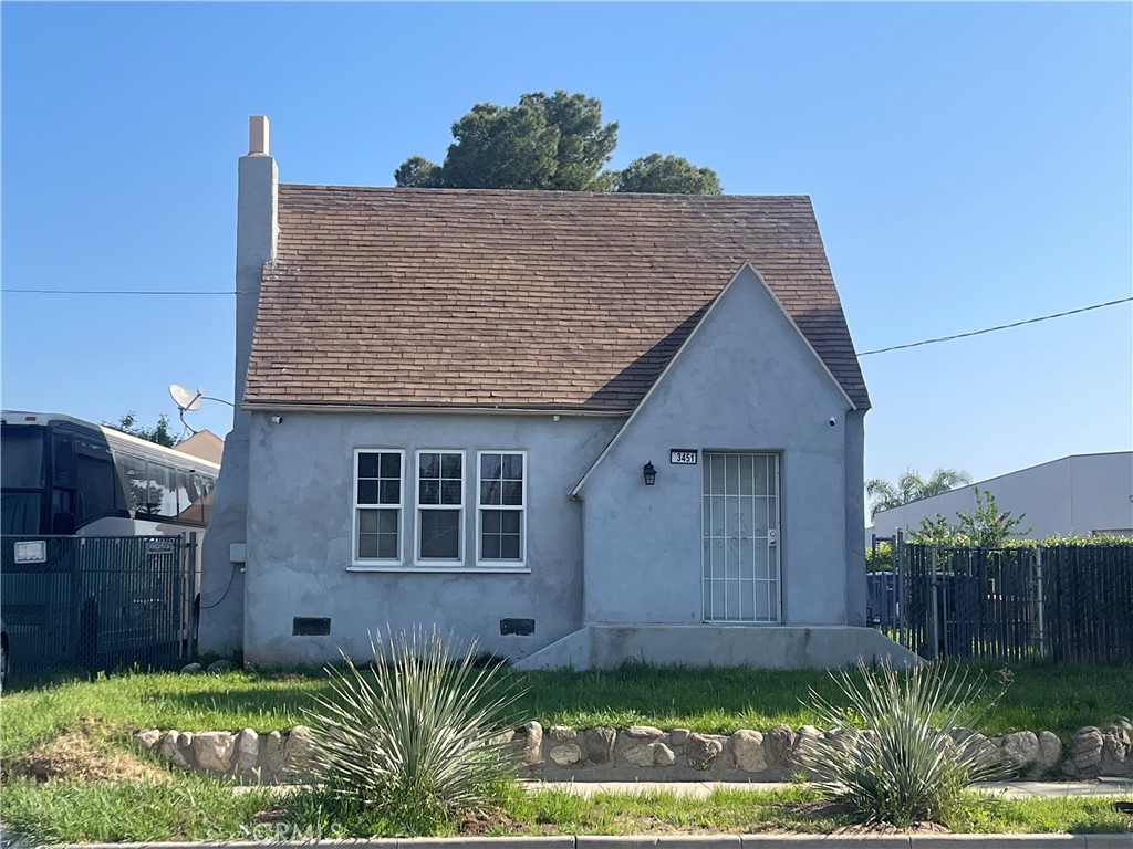 3451 Russell Street Riverside, CA 92501 - Photo 1 of 1 a view of a house with a yard plants and large tree