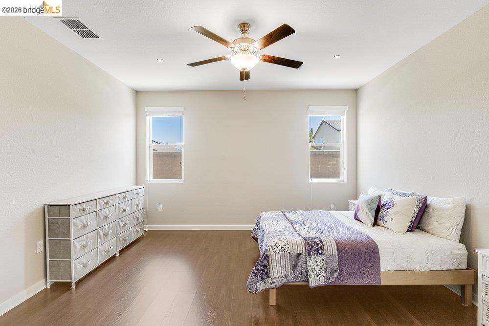 4347 Canada Way Rio Vista, CA 94571 - Photo 22 of 41 Spacious room featuring wood-finish flooring, two large windows, a ceiling fan with integrated lighting, and recessed ceiling lights
