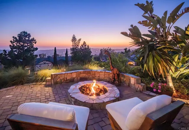 an aerial view of a house with a yard lake view and mountain view in back