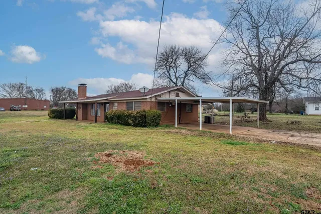 a view of a brick house with a large window
