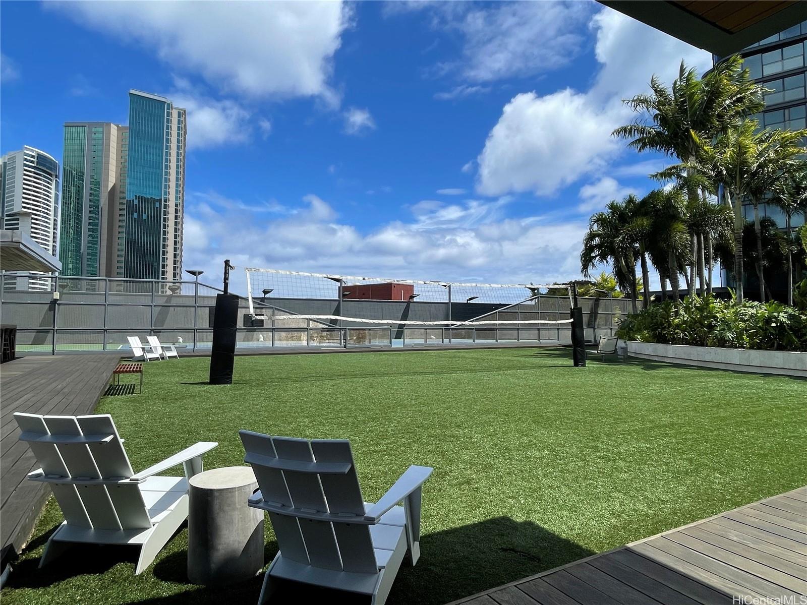 1108 Auahi Street, Unit PH3403 Honolulu, HI 96814 - Photo 22 of 24 a view of a table and chairs in the garden