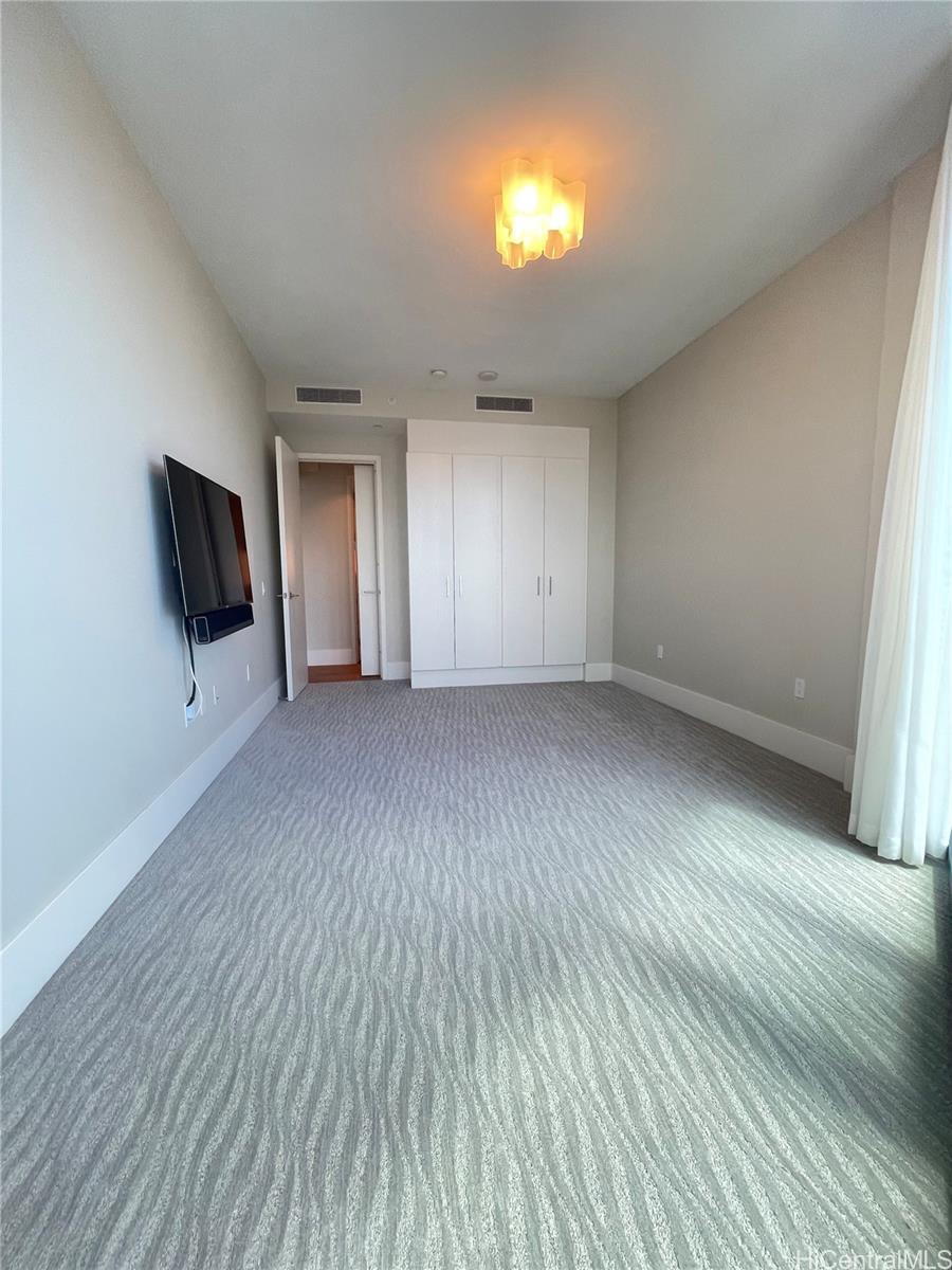 1108 Auahi Street, Unit PH3403 Honolulu, HI 96814 - Photo 10 of 24 wooden floor in an empty room with a window