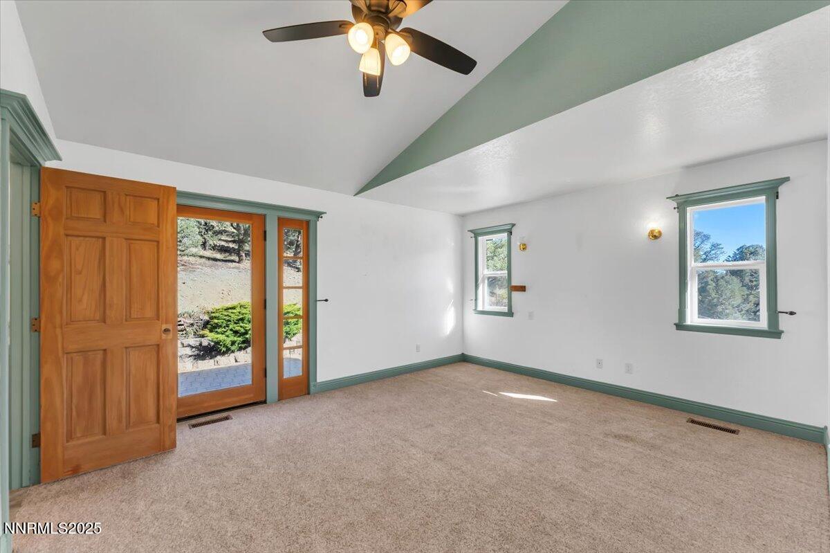 21410 Sazarac Road Reno, NV 89521 - Photo 15 of 41 an empty room with windows chandelier fan and windows