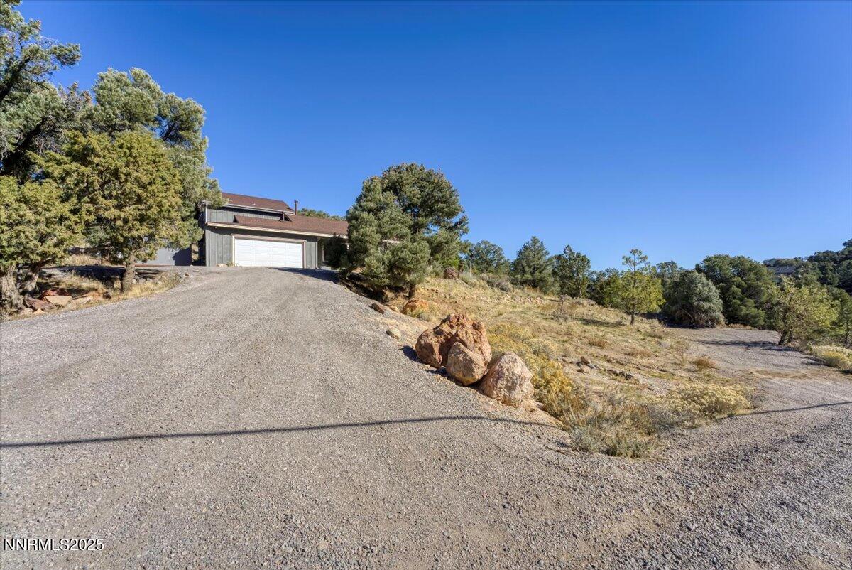 21410 Sazarac Road Reno, NV 89521 - Photo 2 of 41 a view of a dry yard with a tree