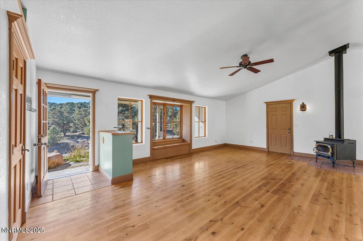 21410 Sazarac Road Reno, NV 89521 - Photo 4 of 41 a view of empty room with wooden floor and fan