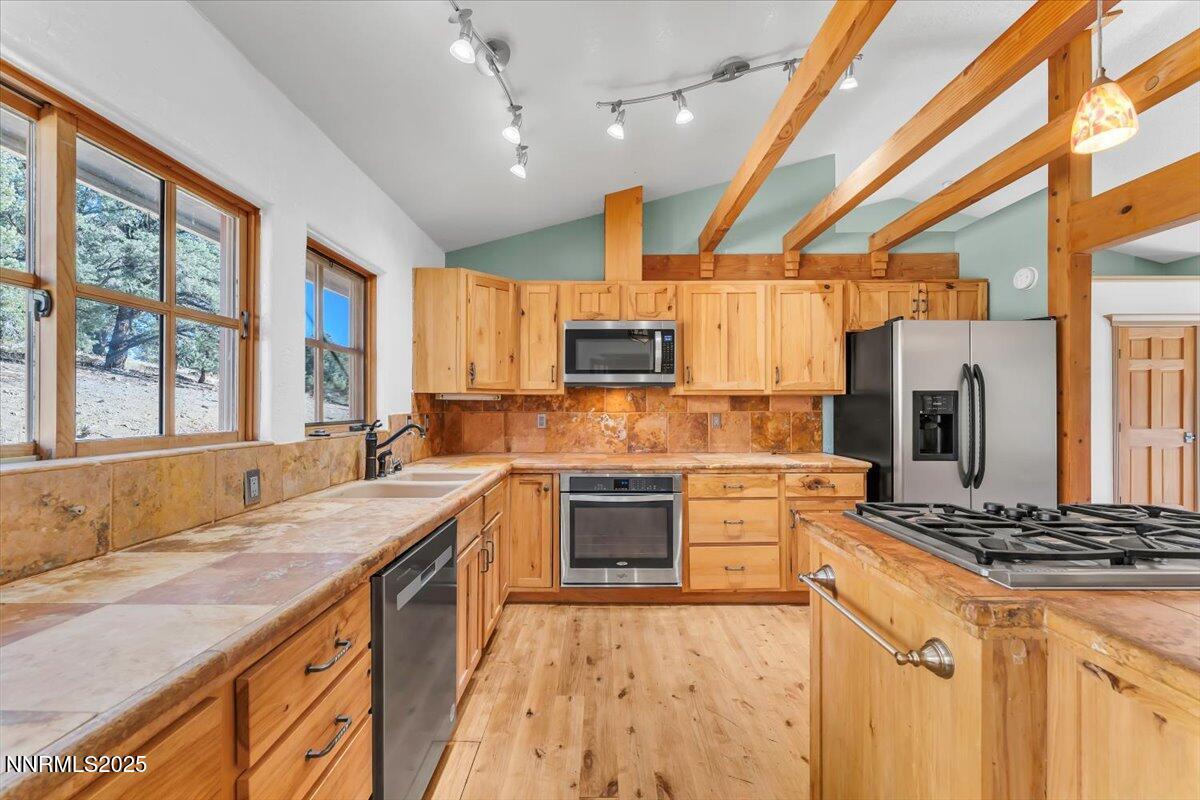 21410 Sazarac Road Reno, NV 89521 - Photo 8 of 41 a kitchen with a stove a sink and a refrigerator