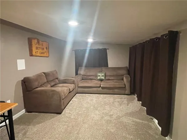 a living room with furniture and a walk in closet