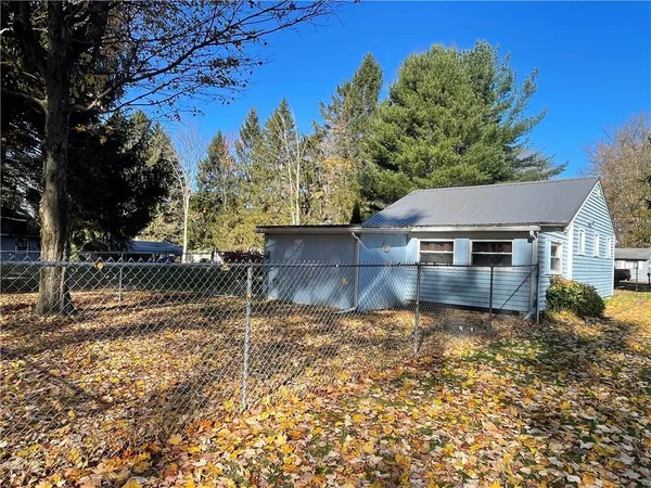 a backyard of a house with table and chairs
