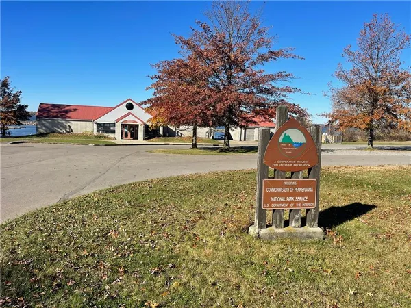a view of a dirt road with a building in the background