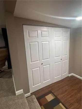 a view of a workspace with furniture and window