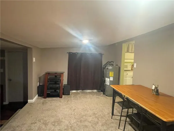 a kitchen with white cabinets and white appliances