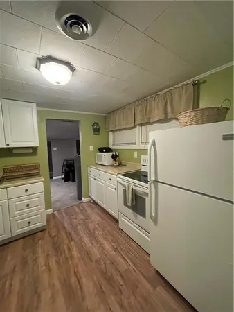 a kitchen with granite countertop a sink and cabinets