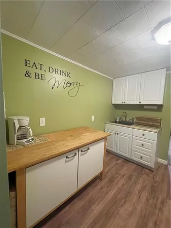 a kitchen with sink cabinets and wooden floor