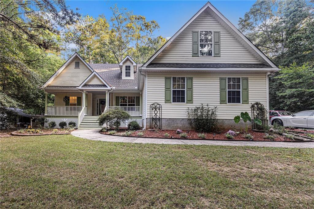 136 Whippoorwill Ridge Road Jackson, GA 30233 - Photo 1 of 1 a front view of a house with a yard and seating space