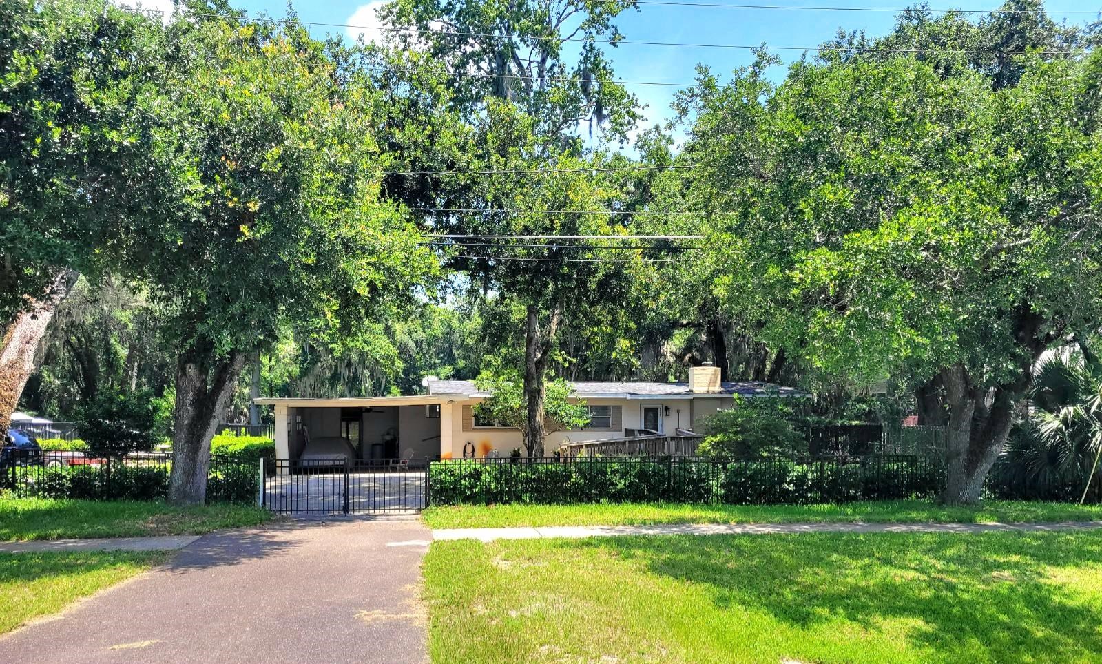 930 Highway 16 St. Augustine, FL 32084 - Photo 10 of 27 a front view of a house with a garden and tree
