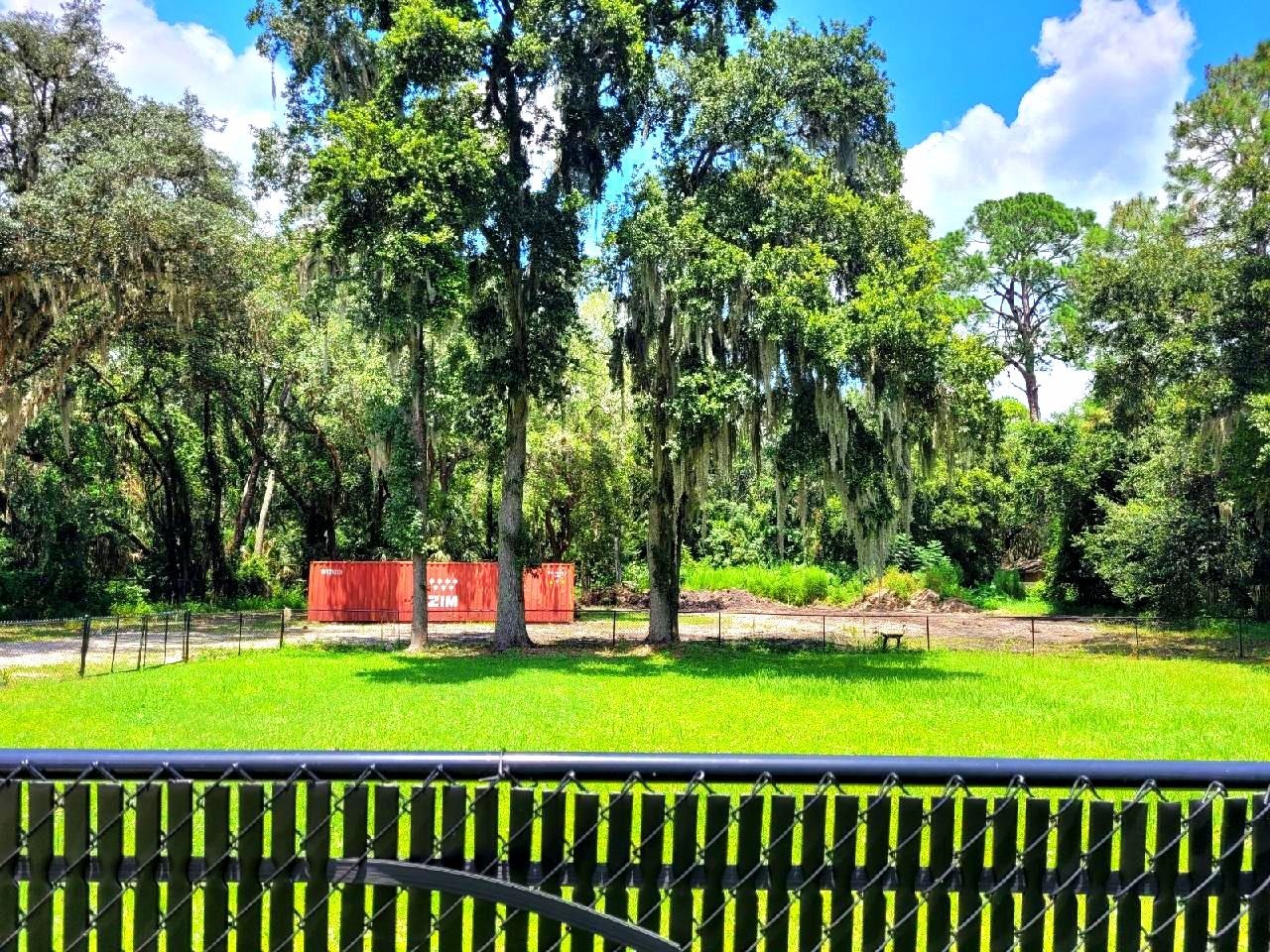 930 Highway 16 St. Augustine, FL 32084 - Photo 16 of 27 a front view of a house with a big yard and trees
