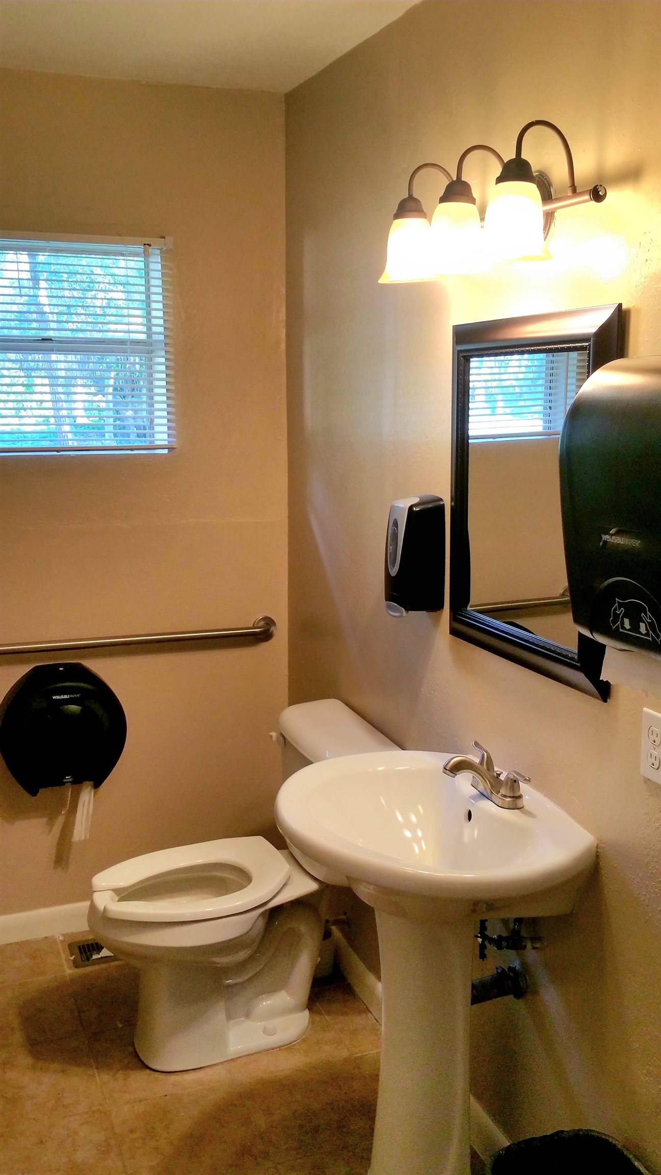 930 Highway 16 St. Augustine, FL 32084 - Photo 18 of 27 a bathroom with a sink a toilet and mirror