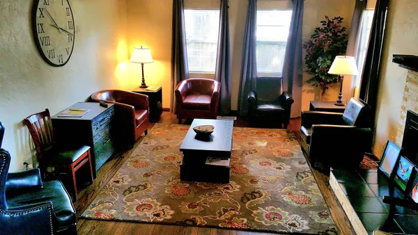 a living room with furniture and a potted plant