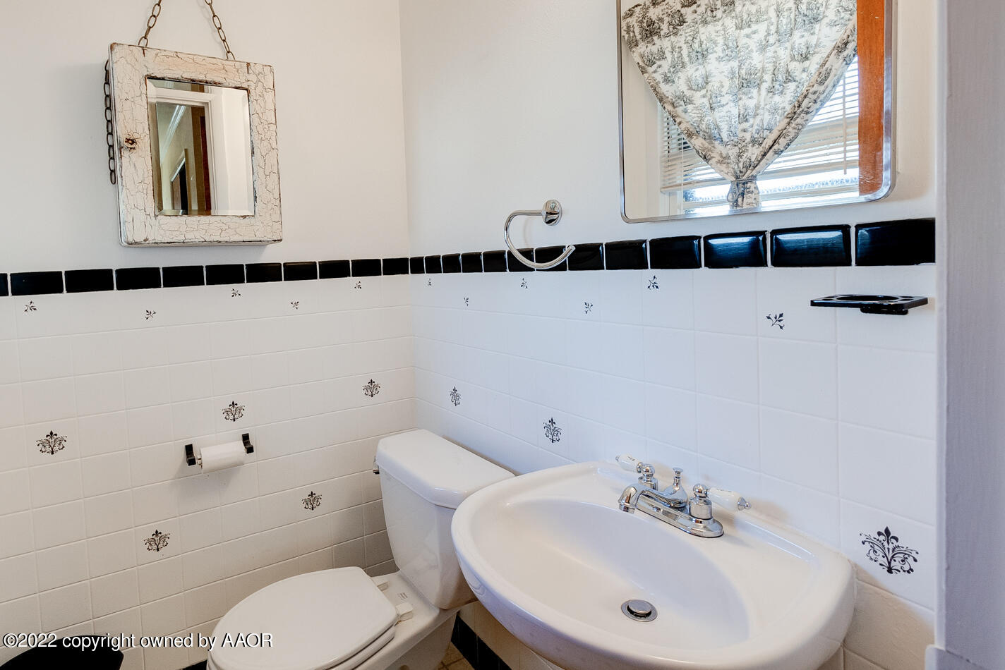 5015 South Milam Street Amarillo, TX 79110 - Photo 12 of 15 a bathroom with a sink and a mirror
