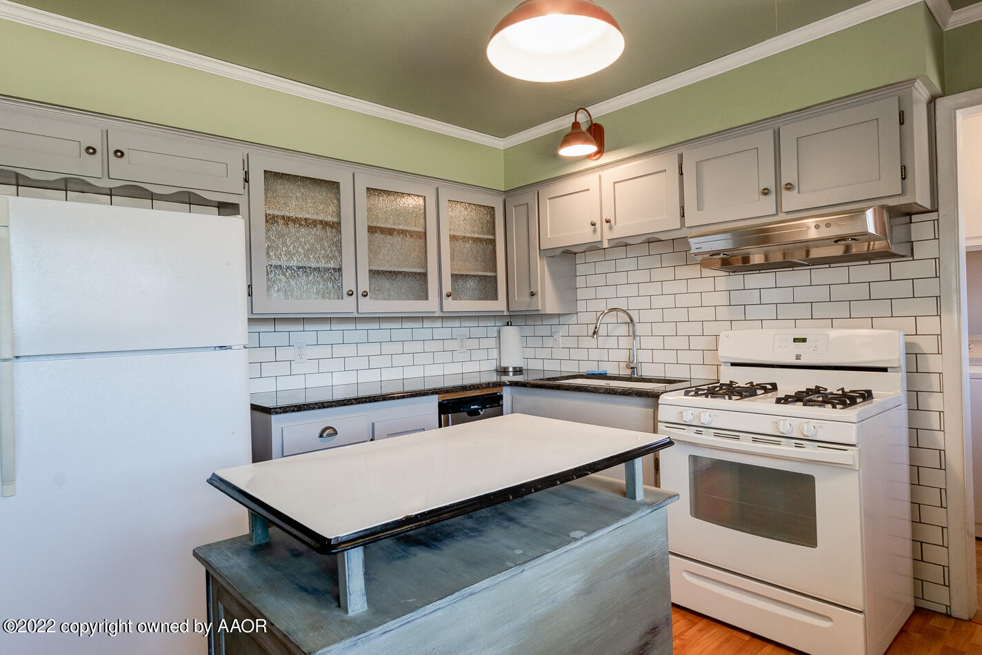5015 South Milam Street Amarillo, TX 79110 - Photo 6 of 15 a kitchen with a stove cabinets and a refrigerator