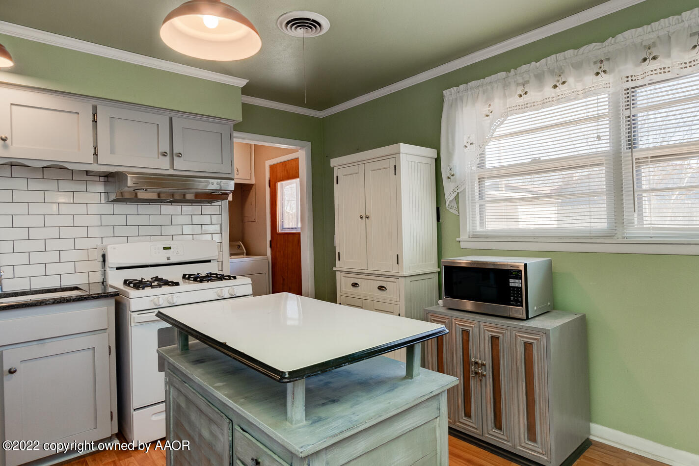 5015 South Milam Street Amarillo, TX 79110 - Photo 7 of 15 a kitchen with a stove and a refrigerator