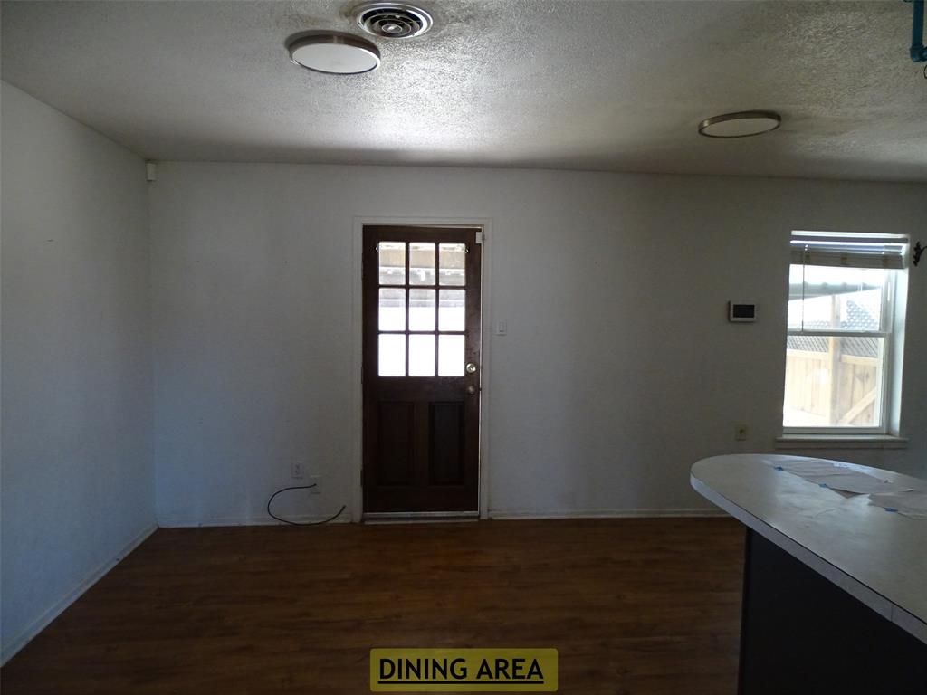 908 Brookside Street Sweetwater, TX 79556 - Photo 5 of 20 an empty room with wooden floor windows and closet