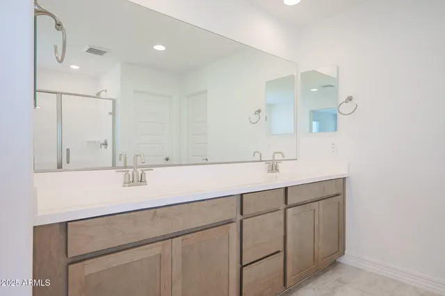 a bathroom with 2 sink and a mirror