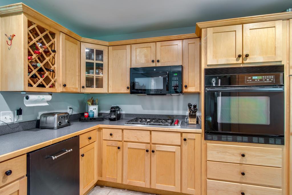 1102 Center Point Road Hendersonville, TN 37075 - Photo 12 of 30 a kitchen with stainless steel appliances granite countertop a stove microwave and cabinets