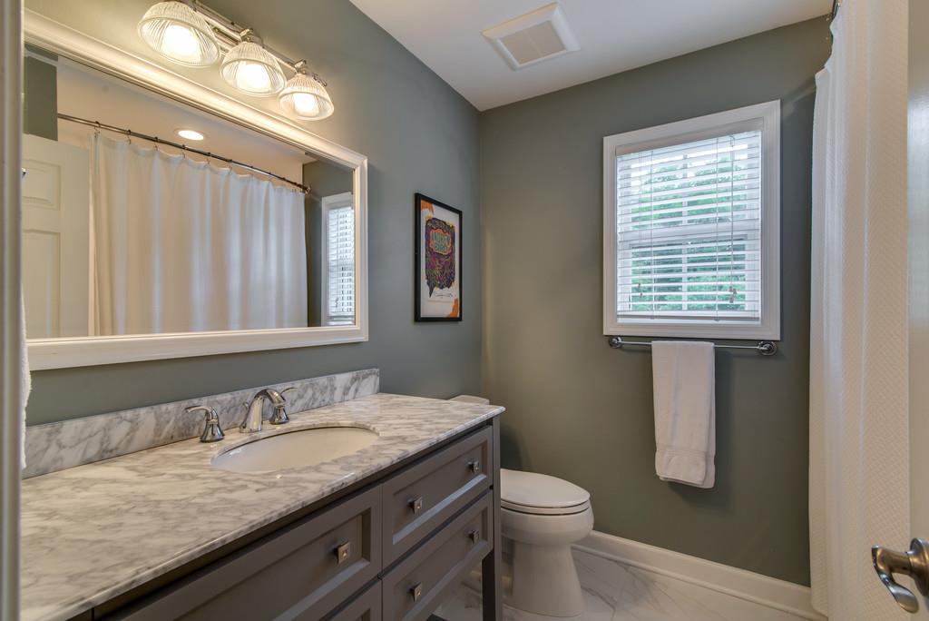 1102 Center Point Road Hendersonville, TN 37075 - Photo 22 of 30 a bathroom with a granite countertop sink toilet and mirror