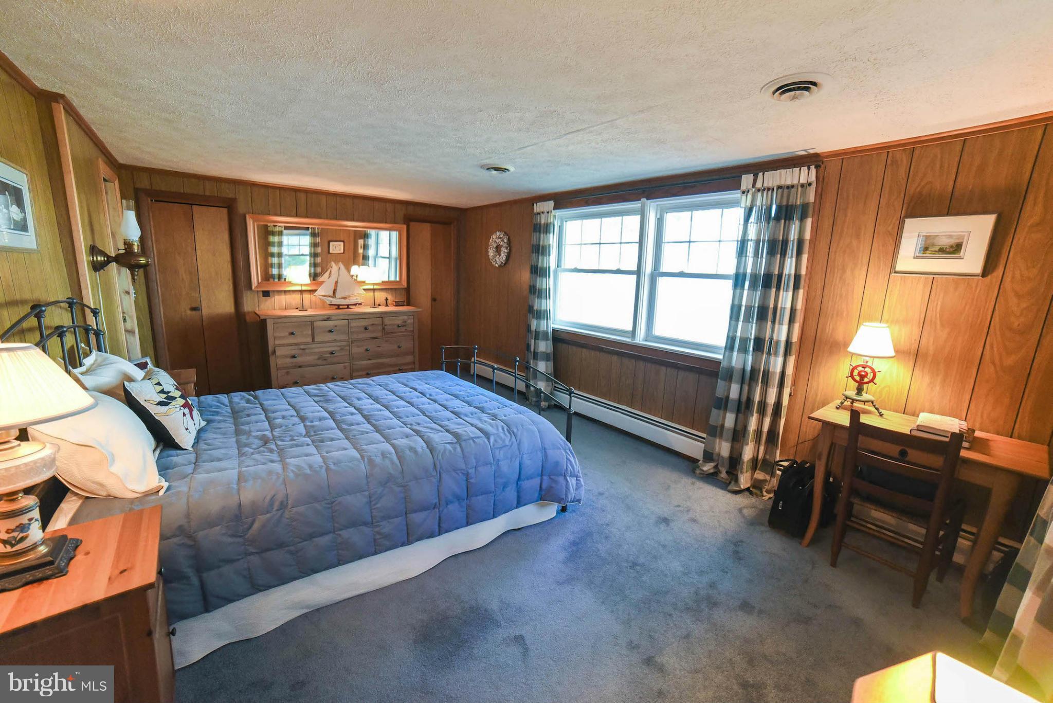 16466 Piney Point Road Piney Point, MD 20674 - Photo 14 of 27 a spacious bedroom with a bed and a window