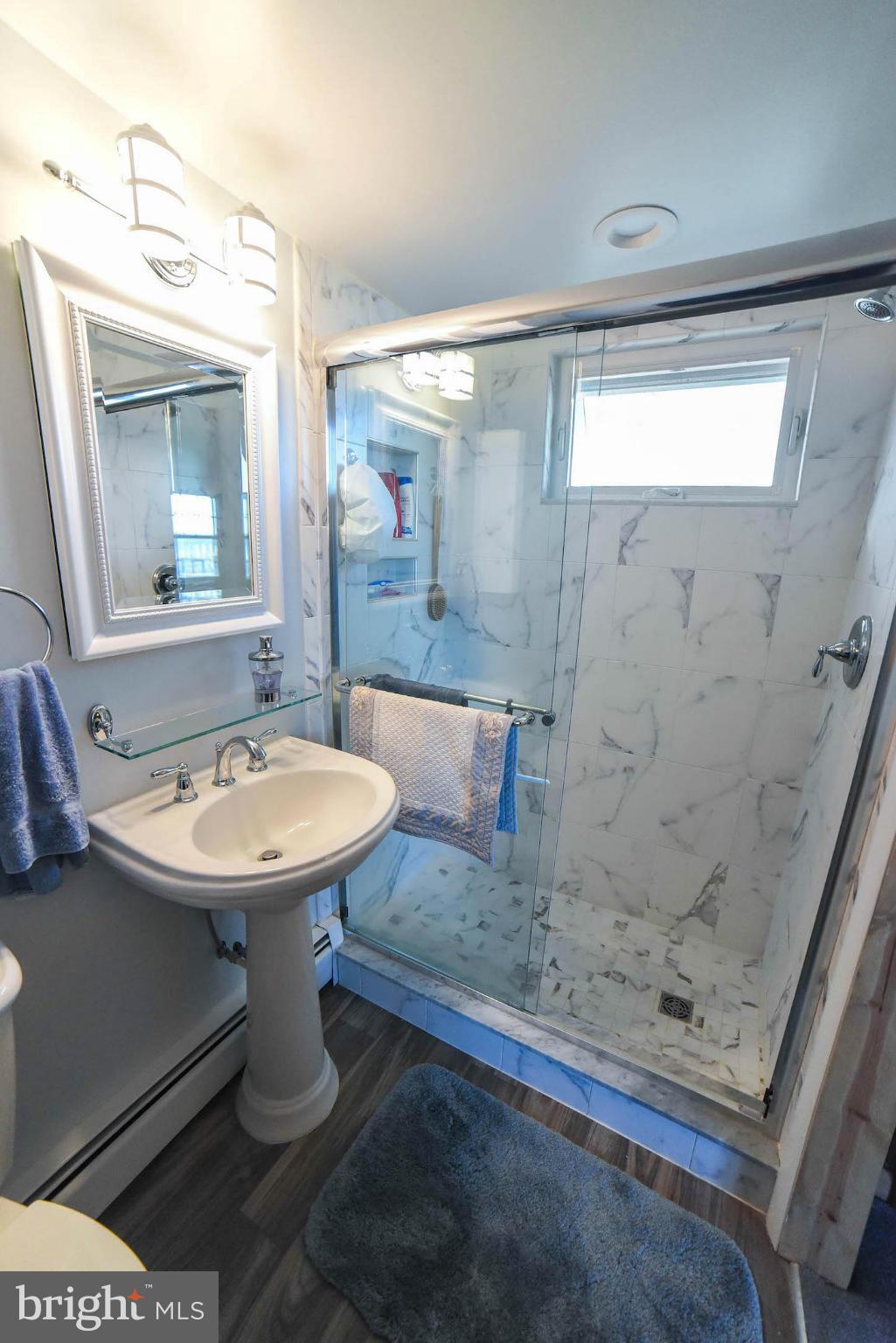 16466 Piney Point Road Piney Point, MD 20674 - Photo 15 of 27 a bathroom with a sink a mirror and a shower
