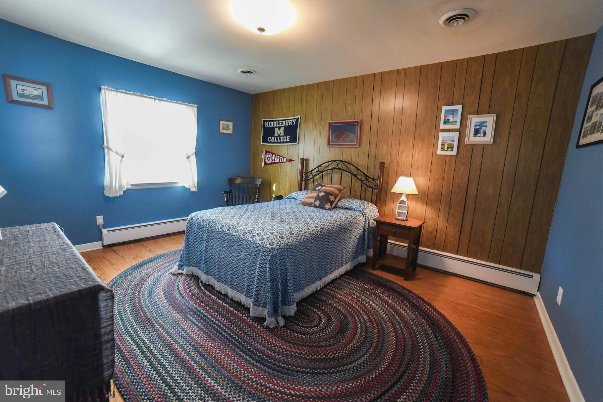 16466 Piney Point Road Piney Point, MD 20674 - Photo 18 of 27 a bedroom with a bed and wooden floor