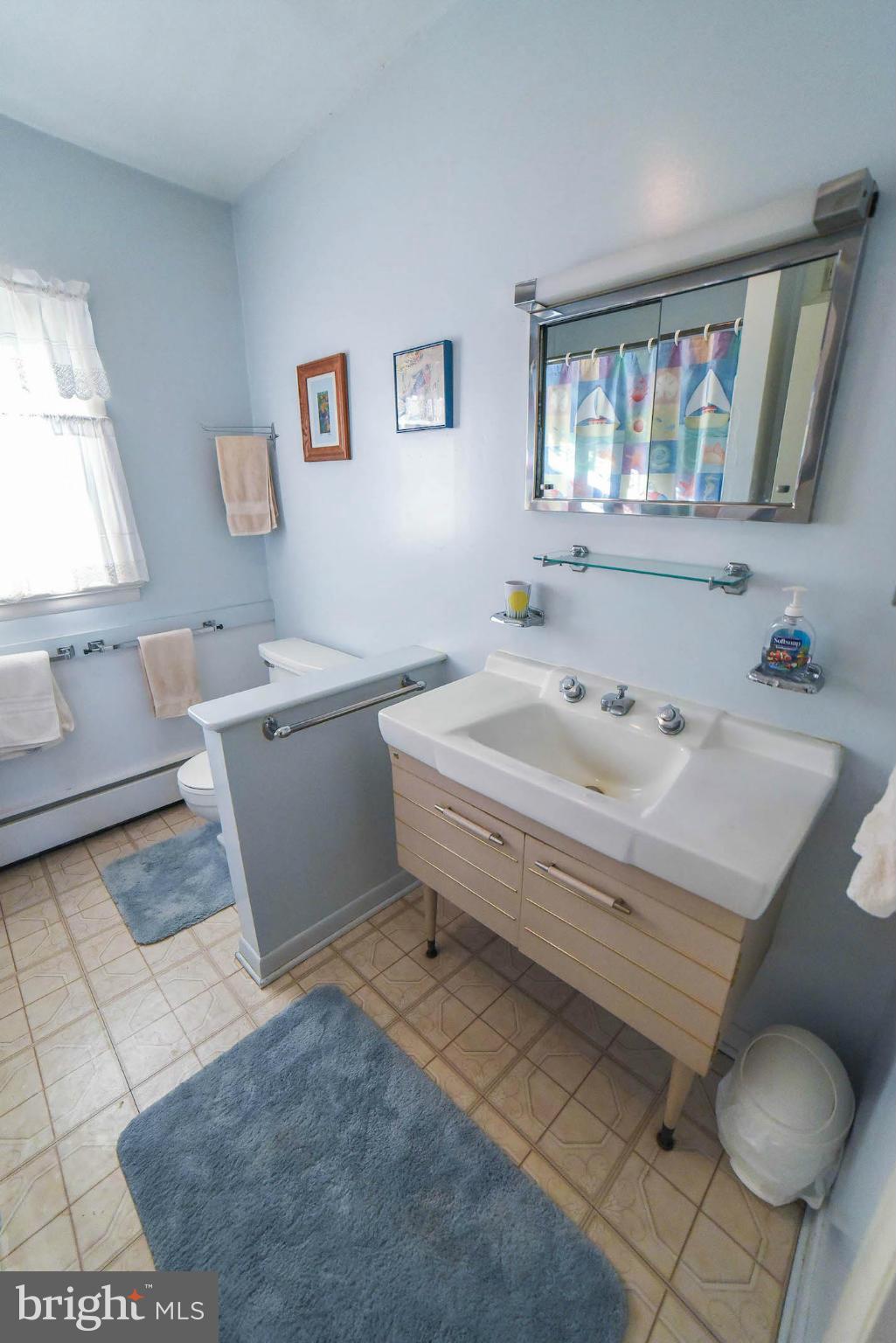 16466 Piney Point Road Piney Point, MD 20674 - Photo 19 of 27 a bathroom with a sink and a mirror