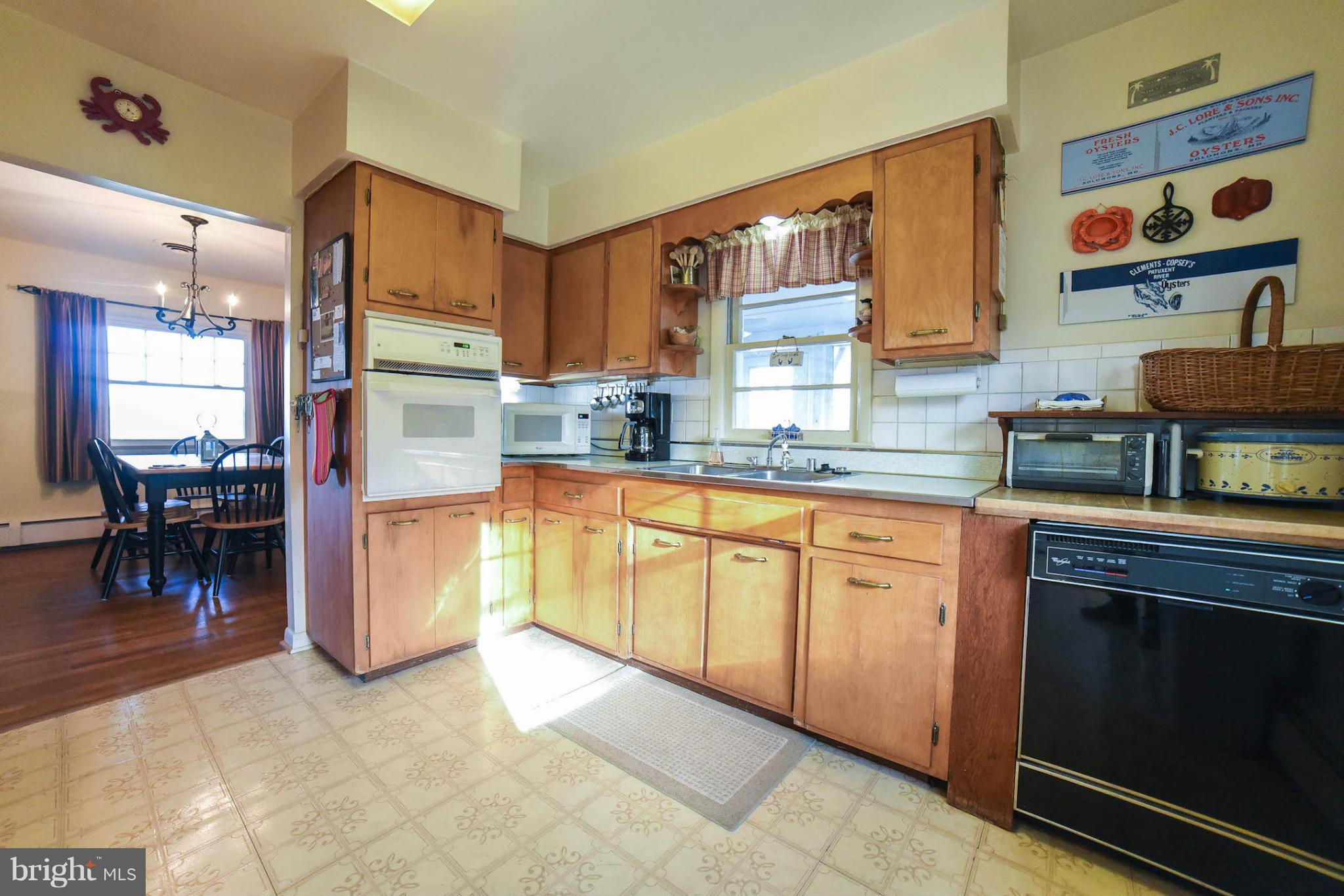 16466 Piney Point Road Piney Point, MD 20674 - Photo 8 of 27 a kitchen with cabinets and chairs