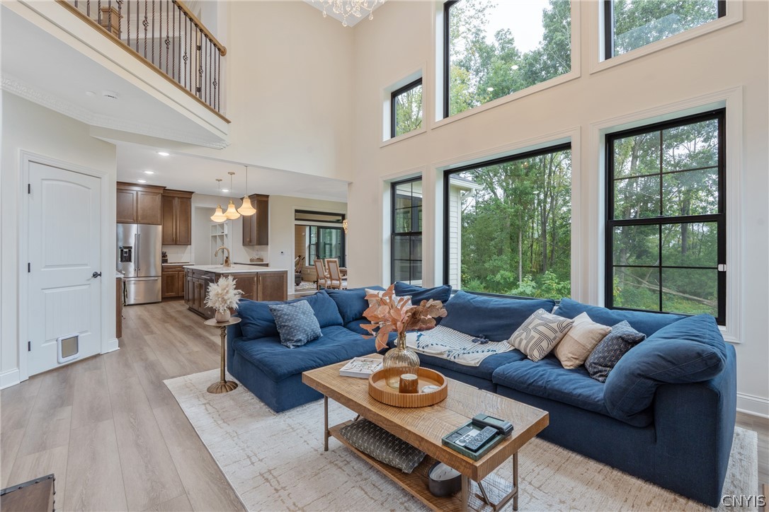 2020 Rubicon Road Lysander, NY 13027 - Photo 8 of 49 Soaring two-story great room framed by massive, sleek windows that flood the space with natural light while offering breathtaking views of the private, tree-lined yard.