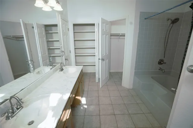 a bathroom with a granite countertop sink a toilet and shower