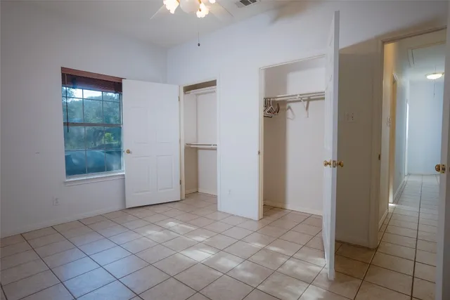 an empty room with windows and closet