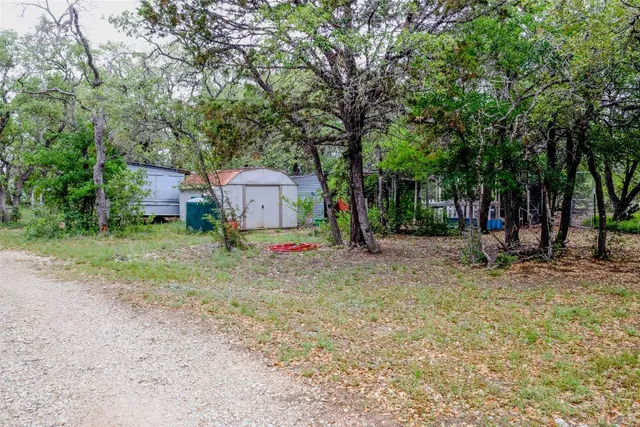 a view of a field with trees in front of it