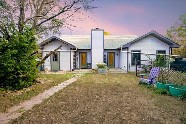 a view of a house with backyard and porch