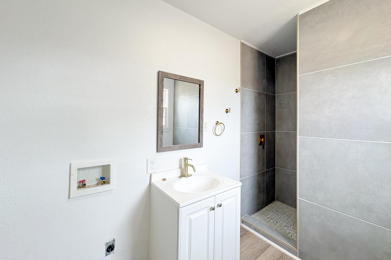 809 West 5th Street Wolfforth, TX 79382 - Photo 12 of 23 a bathroom with a sink and a mirror