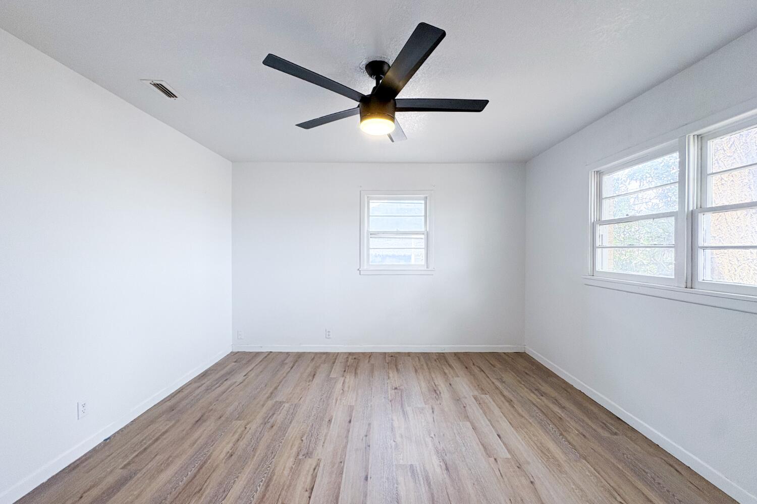809 West 5th Street Wolfforth, TX 79382 - Photo 15 of 23 wooden floor in an empty room with a window