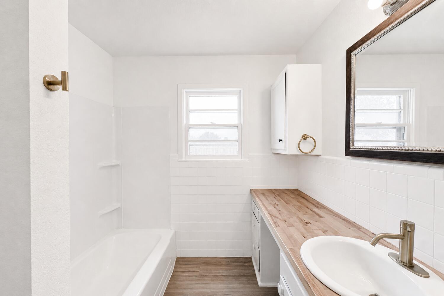 809 West 5th Street Wolfforth, TX 79382 - Photo 16 of 23 a bathroom with a sink and a mirror