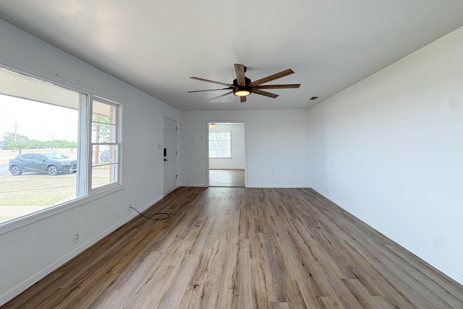 809 West 5th Street Wolfforth, TX 79382 - Photo 4 of 23 wooden floor in an empty room with a window