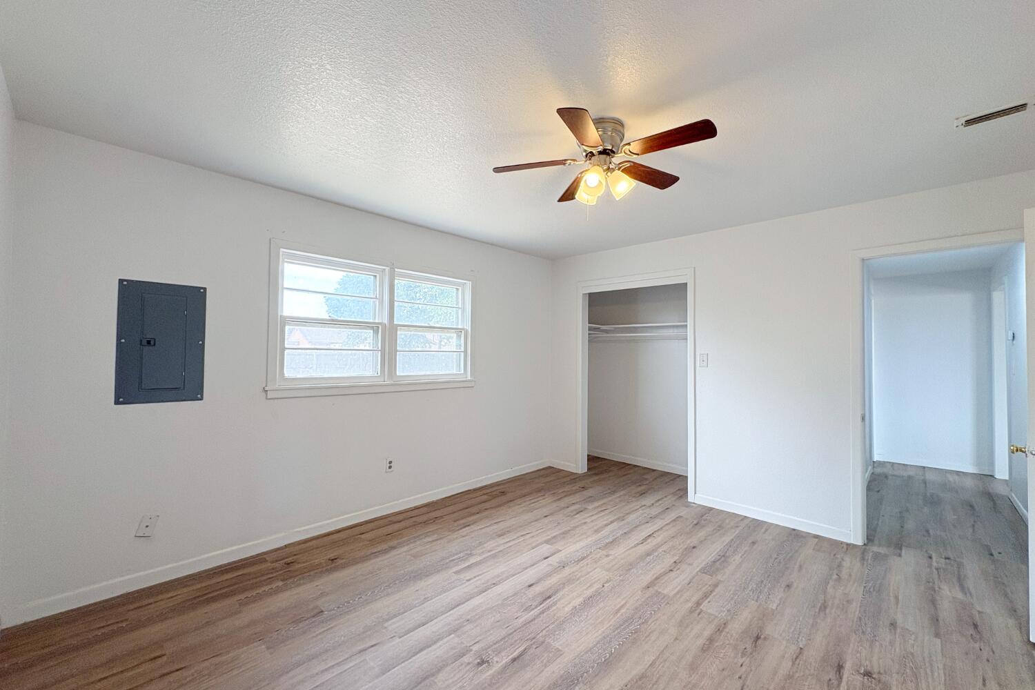 809 West 5th Street Wolfforth, TX 79382 - Photo 9 of 23 a view of empty room with wooden floor and fan